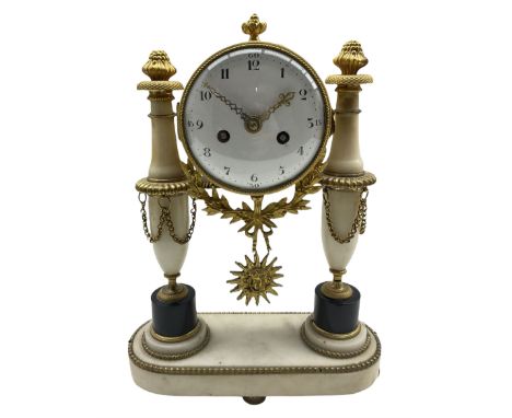 A 19th century French striking mantle clock in a white marble portico case with gilt brass mounts and corresponding decoratio