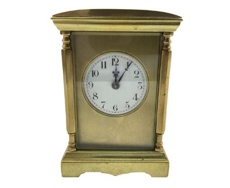 A late 19th century Parisian spring driven table clock with four bevelled glass panels, brass case with a convex top and shap