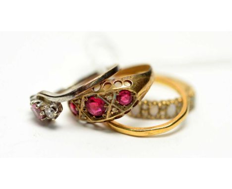 Four rings, comprising a red stone ring on 18ct yellow gold shank; a pink and white stone ring on 9ct white gold shank; a 22c