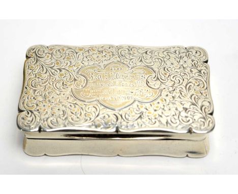 An Edward VII silver snuff box, by Sanders &amp; McKenzie, Chester 1906, of shaped rectangular form with presentation inscrip