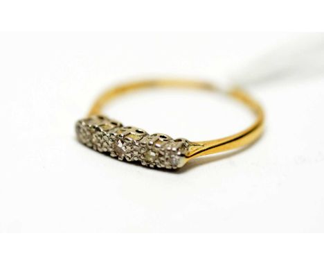 A five stone diamond ring, the brilliant cut diamonds in illusion setting, the yellow metal shank stamped '18ct &amp; Pt', ri