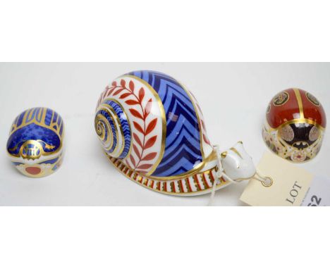 Royal Crown Derby snail paperweight; along with a Royal Crown Derby 'Millennium Bug' paperweight' and a Royal Crown Derby '2 