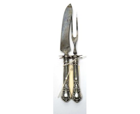 An early 20th Century American Sterling standard silver handled game knife and fork, by Gorham, in Queens pattern, the knife 