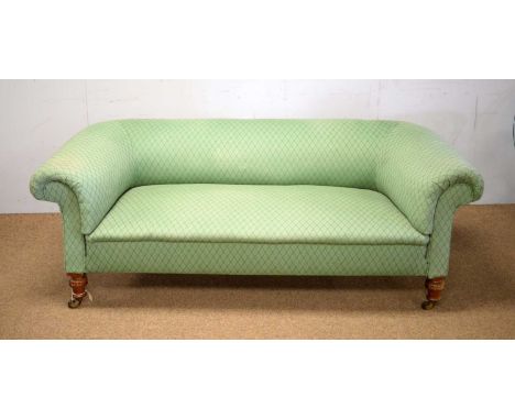 A Victorian walnut Chesterfield sofa, upholstered in green lozenge design fabric, turned legs on castors, 186 x 88 x 71cms hi