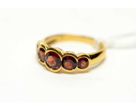 A five stone garnet ring, the circular facet cut graduated garnet on 9ct yellow gold shank, ring size P.