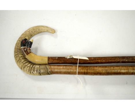 Horn handled wooden walking stick; and another walking stick, the horn handle painted with ducks head motif decoration. (2) 