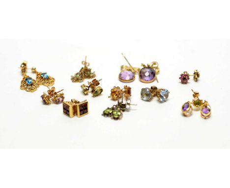 A collection of gem set earrings, including citrine, amethyst, peridot, topaz and others.