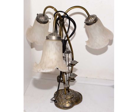 A 20th Century three-branch gilt metal table lamp, moulded with flower and leaf, with opaque glass shade, 52cms high.