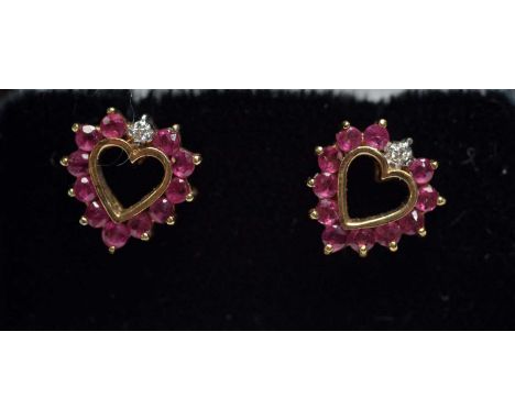 A pair of ruby and diamond heart shaped stud earrings, in 9ct yellow gold mounts,