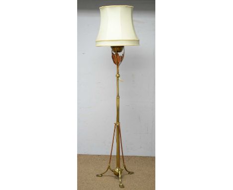 An Arts &amp; Crafts brass oil lamp stand, later converted to electricity, with modern shade, 208cms high.