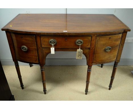 A Regency bowfront mahogany cottage sideboard, the shaped top with ebony stringing above a central frieze drawer, flanked by 
