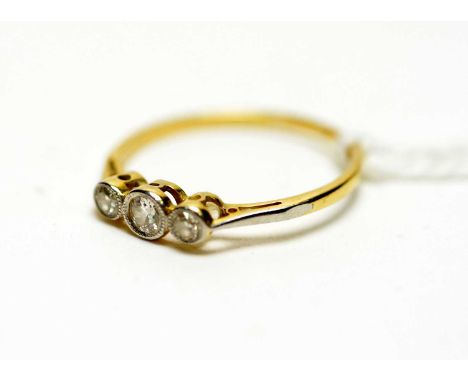 A three stone diamond ring, the three brilliant cut diamonds weighing a total of approximately 0.20 carats, on yellow metal s