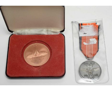 A 1936 German Olympic medal, on ribbon; together with a Montréal Olympic bronze medal 1976, cased.