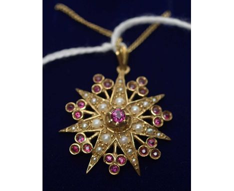 A Victorian style seed pearl and ruby star shaped pendant, in 9ct yellow gold mount, on 9ct yellow gold curb link chain, 6.8g