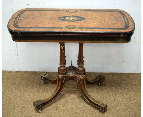 A Victorian inlaid, ebonised and burr walnut card table, the shaped rectangular hinged swivel top opening to reveal a baize-l