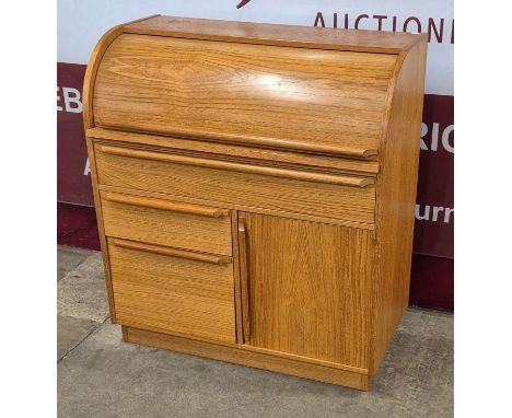 A teak cylinder bureau 