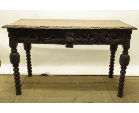 Victorian carved oak side table, with two scroll carved frieze drawers, on bobbin turn supports, W122cm D60cm H75cm 