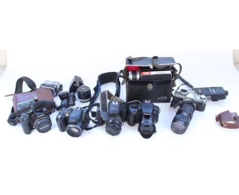 Collection of cameras and camera equipment and accessories to include Canon AE-1 with Vivitar 75-205mm 1:38 lens, Fuji S-7000