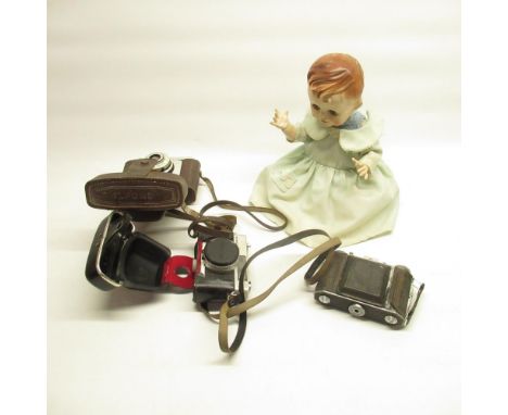 Mid C20th composition doll with jointed limbs in blue green Christening gown, Ilford Sporti camera, Konica C35 camera, anothe
