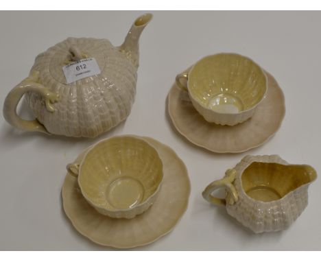 7 PIECES OF BELLEEK PORCELAIN TRIDACNA PATTERN TEA WARE COMPRISING LIDDED TEAPOT, 2 CUPS, 2 SAUCERS &amp; CREAM JUG - SECOND 