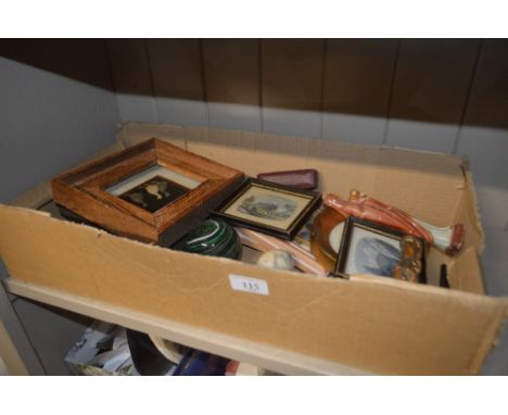 A tray containing a green Art Glass paperweight; various small prints; two religious figures; a small compass; a set of Dunhi