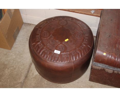 A brown leather pouffe