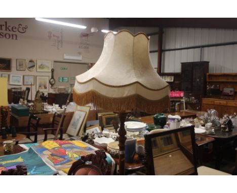 A mahogany standard lamp and shade 