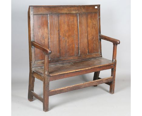 An 18th century provincial oak panel back settle with solid seat and block legs, height 117cm, width 116cm, depth 45cm (alter