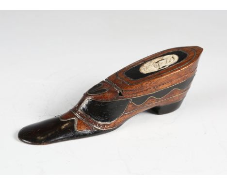 A 19th century mahogany and ebony novelty snuff box in the form of a shoe, with brass line inlay and carved bone portrait to 