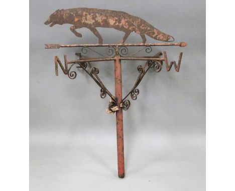 A 20th century wrought iron weather vane with a sheet metal fox surmount above a central shaft with compass point indicators,