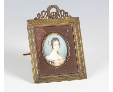 An early 20th century Continental portrait miniature on ivory, depicting a young lady wearing medieval costume, bearing indis