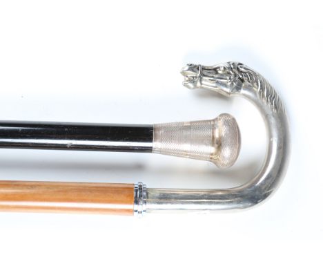 An early 20th century ebonized walking stick with silver pommel, London 1921, length 90cm, together with a modern walking sti