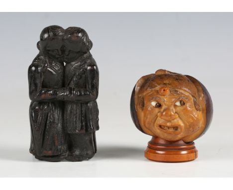 A 19th century novelty coquilla nut snuff box, modelled as a grotesque face, inset with glass eyes, height 6cm, together with