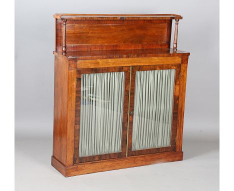 A Regency rosewood chiffonier, the shelf back above a pair of glazed doors, height 121cm, width 107cm, depth 29.5cm.Buyer’s P