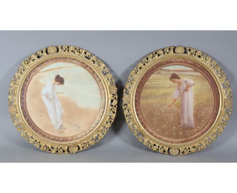 A pair of early 20th century gilt gesso circular picture frames with pierced shell and scroll form border, each framing a pri