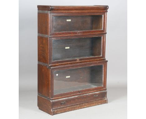 A George V oak Globe Wernicke graduated three-tier bookcase, fitted with a drawer to base, height 123cm, width 86cm, depth 29