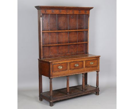 A late George III provincial oak dresser, the plate rack above three frieze drawers and a pot shelf, height 184cm, width 130c