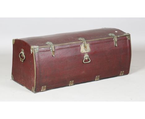 An early/mid-20th century automobile trunk, covered in a claret faux snakeskin canvas, height 40cm, width 100cm.Buyer’s Premi