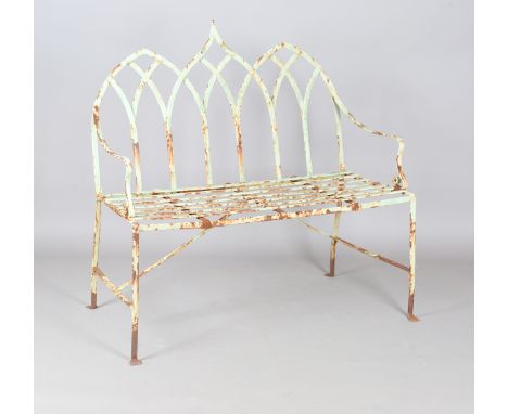 A late 19th/early 20th century green painted wrought iron garden bench with Gothic arch back and slatted seat, height 105cm, 