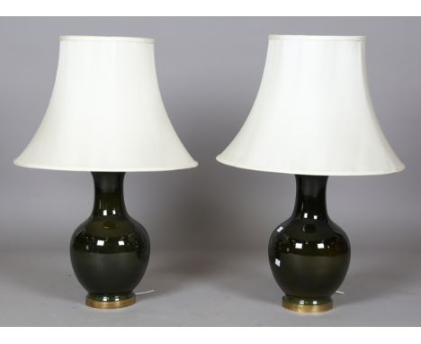 A pair of 20th century gilt metal mounted green glazed ceramic table lamps with cream silk shades, height 75cm.Buyer’s Premiu