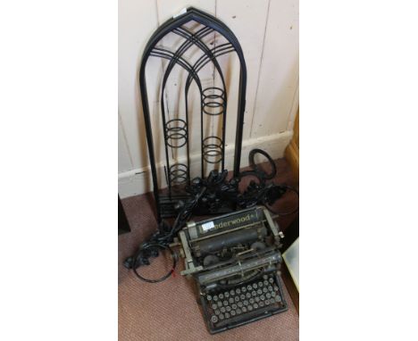 An iron hanging stick stand, horseshoe and three fold stands plus an old Underwood typewriter