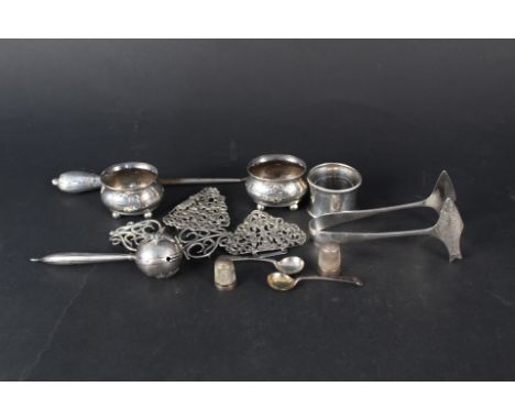 A mixed lot, two silver nurses buckles (one as found), two silver salts, a silver napkin ring, white metal rattle (as found) 