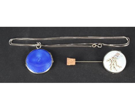 A white metal circular photo locket with blue enamel decoration and a white metal circular locket with enamel and floral deco