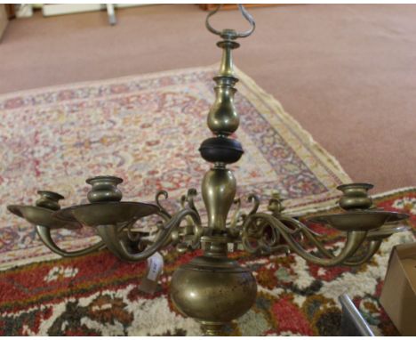 A heavy six branch brass chandelier, 23" high and 25 1/2" wide