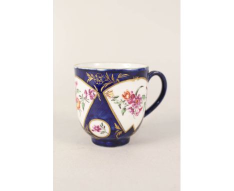 A Worcester blue ground cup with floral reserves and gilt decoration