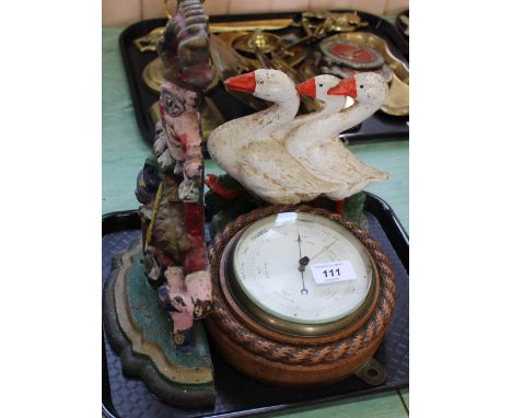 Iron Mr Punch and ducks doorstops plus a circular oak barometer