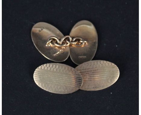 A pair of oval 9ct gold cufflinks with engine turned decoration