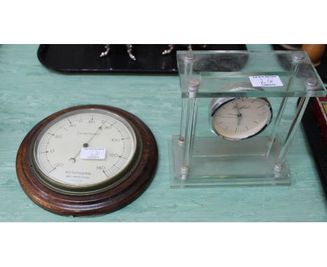 An oak aneroid barometer, Rototherm thermometer plus a perspex cased clock