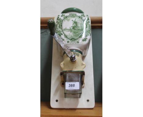 A green Delft Pottery coffee grinder
