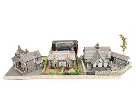 A well-built diorama for a OO gauge model railway layout comprising a school with playground, terraced housing and a Post Off